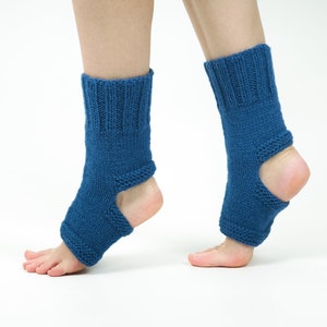 May include: A pair of blue knitted ankle warmers with an opening at the heel. The warmers are made of a soft, textured yarn.