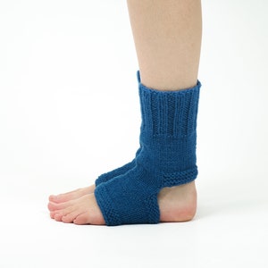 May include: A pair of blue knitted ankle socks with an open heel design. The socks are made of a soft, comfortable material and are perfect for wearing around the house or for yoga.