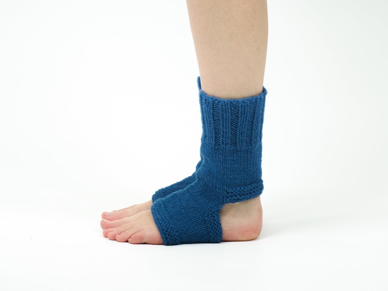 May include: A pair of blue knitted ankle socks with an open heel design. The socks are made of a soft, comfortable material and are perfect for wearing around the house or for yoga.