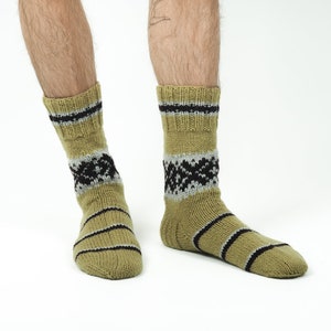 May include: A pair of green and black patterned socks with a striped design.