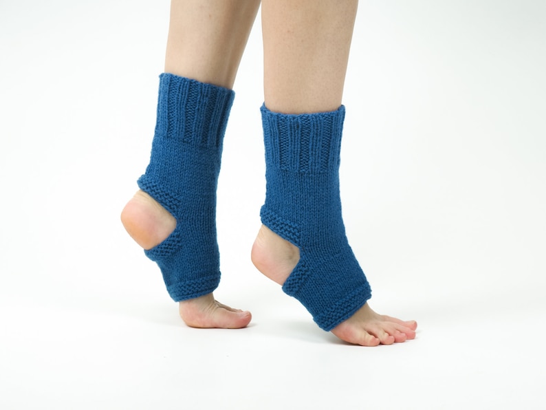 May include: A pair of blue knitted ankle warmers with an opening at the heel. The warmers are made of a soft, stretchy material and are perfect for keeping your feet warm in the winter.