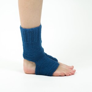 May include: A pair of blue knitted ankle socks with an open heel design. The socks are made of a soft, comfortable material and are perfect for wearing around the house or for yoga.