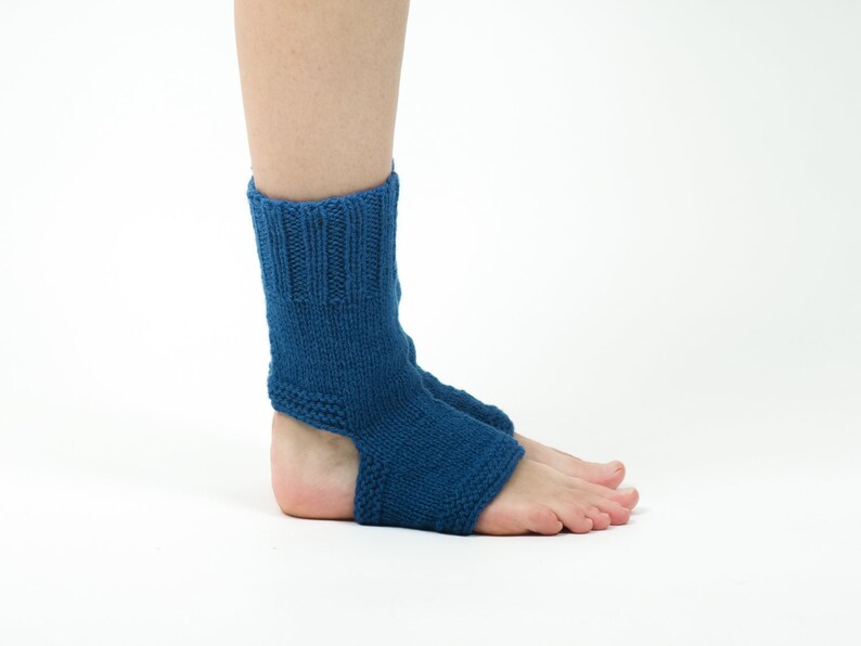 May include: A pair of blue knitted ankle socks with an open heel design. The socks are made of a soft, comfortable material and are perfect for wearing around the house or for yoga.