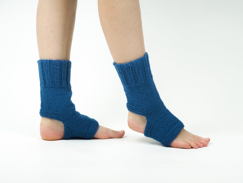 May include: A pair of blue knitted ankle warmers with an open heel design. The warmers are made of a soft, comfortable material and are perfect for keeping your feet warm in the winter.
