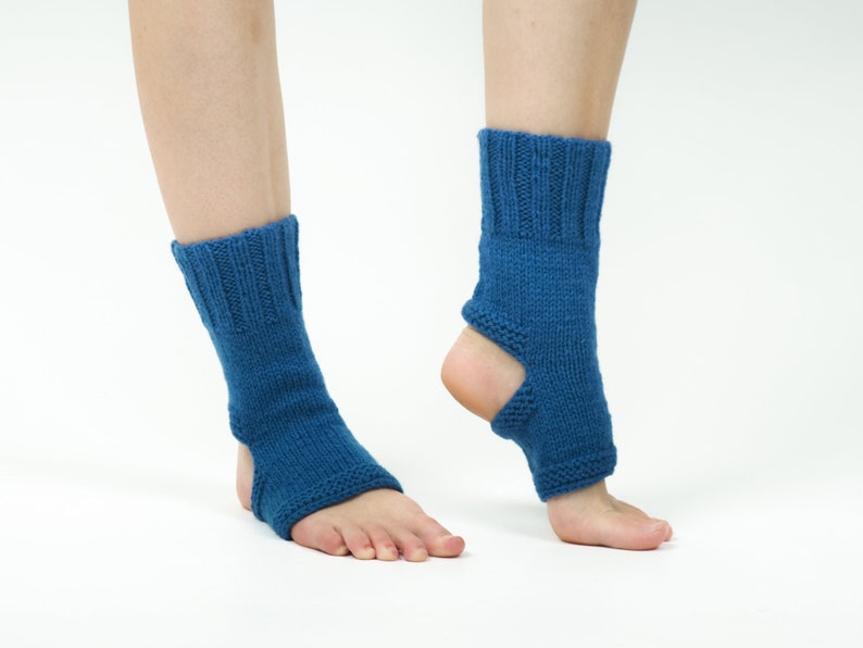 May include: A pair of blue knitted ankle warmers with an opening at the heel. The warmers are made of a soft, stretchy material and are perfect for keeping your feet warm in the winter.