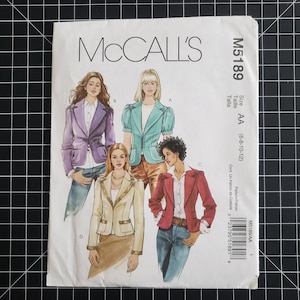 May include: A McCall's sewing pattern, M5189, featuring illustrations of women's blazers in various styles. The pattern includes sizes AA (6-8-10-12). The cover displays a purple, teal, cream, and red blazer designs.