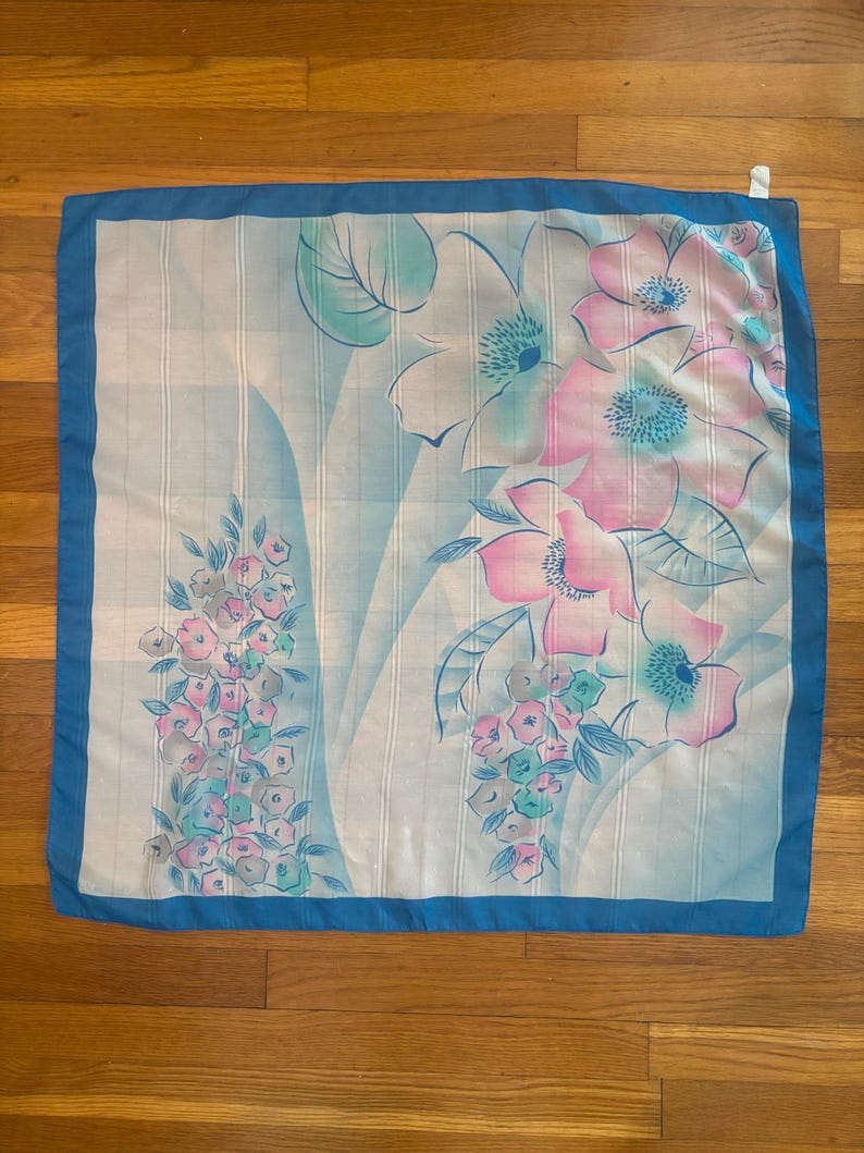 Vertical back view of 1980s vintage large pink, blue, and white floral print square sheer striped polyester scarf.