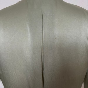 Detail view of 2000s y2k vintage new with tags sage green silk charmeuse robe by Patricia Fieldwalker, size medium to large. Showing the pleat at the center back.