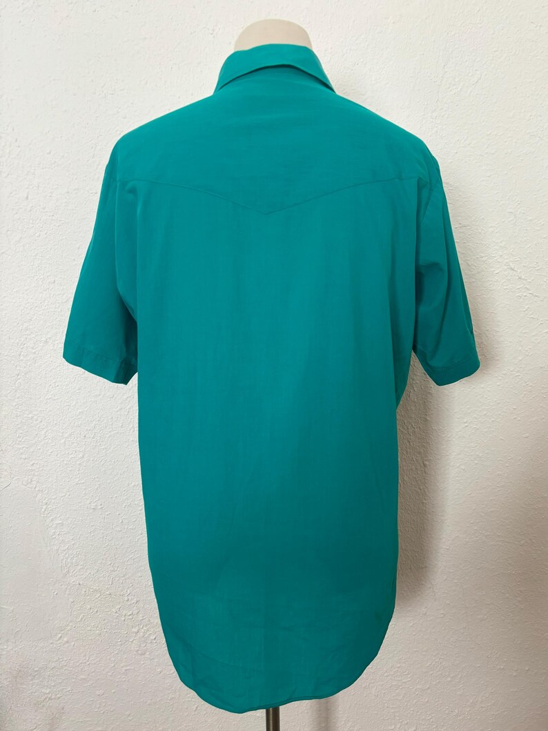 Back view of 1980s vintage teal pearl snap short sleeve western shirt, by Sheplers, size medium to large.