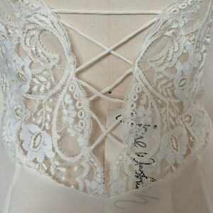 Detail view of 2000s y2k vintage new with tags white georgette and lace sheer floor length nightgown with train by Jane Woolrich, size extra small to small. Showing the open back with faux lacing detail.