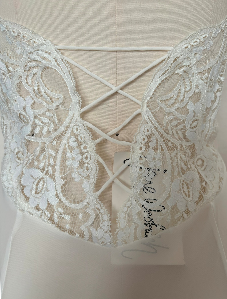 Detail view of 2000s y2k vintage new with tags white georgette and lace sheer floor length nightgown with train by Jane Woolrich, size extra small to small. Showing the open back with faux lacing detail.