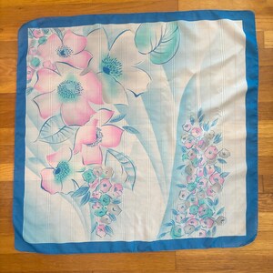 Vertical front view of 1980s vintage large pink, blue, and white floral print square sheer striped polyester scarf.