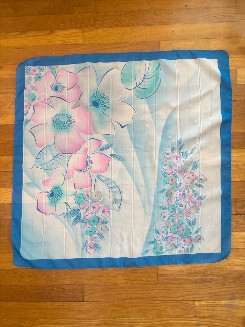 Vertical front view of 1980s vintage large pink, blue, and white floral print square sheer striped polyester scarf.