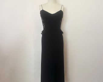 May include: A black maxi dress with a lace panel on the sides. The dress has a sweetheart neckline and thin straps.