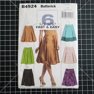 May include: A sewing pattern for six different skirts. The pattern is called "six sew FAST & EASY" and is for sizes 6-8-10-12. The skirts are shown in different colors and fabrics, including brown, green, black, blue, pink, and purple.