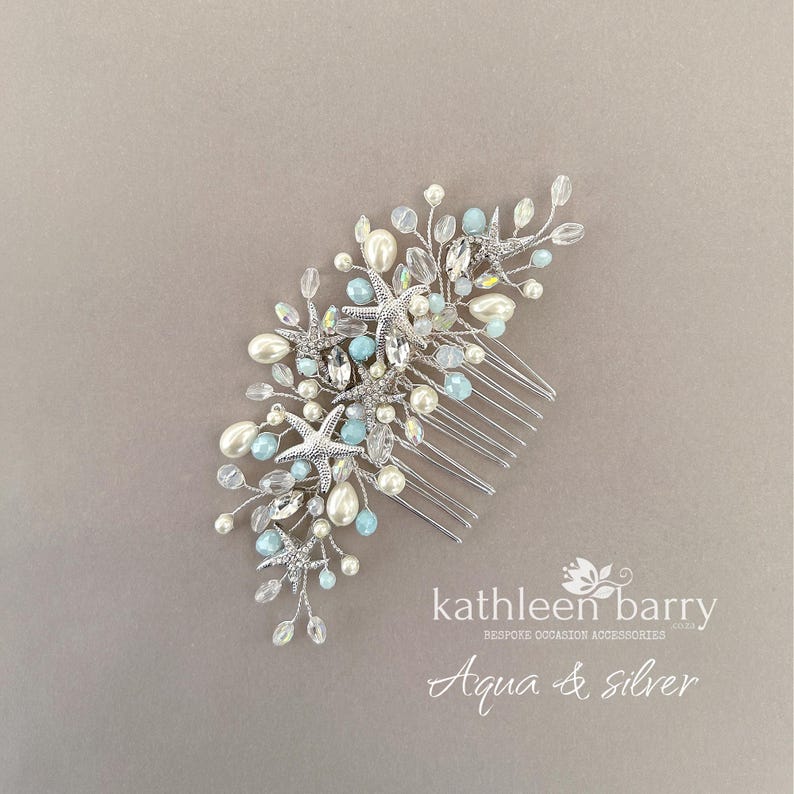 May include: A silver hair comb featuring a cluster of starfish, white pearls, and light blue beads on thin wire branches. The text kathleen barry bespoke occasion accessories and Aqua & silver is printed in white in the bottom right corner.