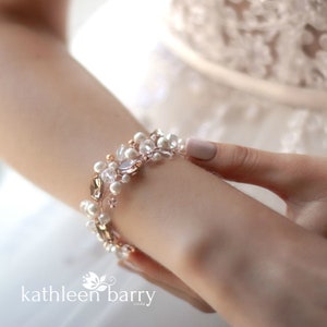 May include: A delicate bracelet with gold and silver beads, pearls, and crystals. The bracelet is perfect for a wedding or other special occasion.