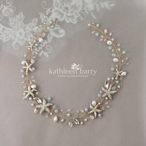 May include: Gold and blue starfish hair vine with pearls and crystals. The vine is made of wire and is flexible. It is perfect for a beach wedding or a summer party. Kathleen Barry Bespoke Occasion Accessories.