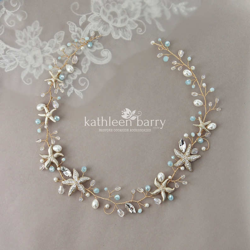 May include: Gold and blue starfish hair vine with pearls and crystals. The vine is made of wire and is flexible. It is perfect for a beach wedding or a summer party. Kathleen Barry Bespoke Occasion Accessories.
