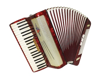 May include: A red accordion with a white and red bellows and a silver-coloured front panel. The accordion has a keyboard with white and black keys.