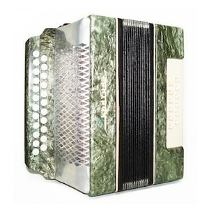 May include: A green accordion with black bellows and white buttons. The accordion has a silver metal plate with the word "Тула" written on it.