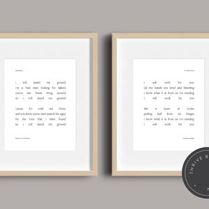 May include: Two framed prints with beige frames, each displaying black text on a white background. The left print features a poem titled "Chapter 4", while the right print has a poem titled "In Your Eyes". A black circular logo is in the bottom right corner.