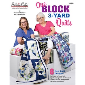 May include: Two women smiling, seated with quilts. The quilts feature blue and white geometric patterns and floral designs. The book cover reads "One Block 3-Yard Quilts" and "Fabric Cafe". The image also includes the text "8 New Quilt Designs!"