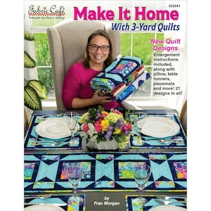 May include: A woman holds a stack of colorful quilts, table runners, and placemats. The image features a table setting with matching placemats and a table runner. The text "Make It Home With 3-Yard Quilts" is visible, along with "New Quilt Designs".