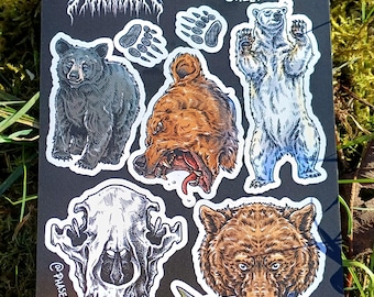 May include: A black and white sticker sheet featuring bear illustrations. The sheet includes a black bear, a brown bear, a polar bear, a bear skull, and a brown bear with a fish in its mouth. The sheet also includes three bear paw prints. The sheet is labelled "PATREON SEPTEMBER 2024 STICKER SHEET".