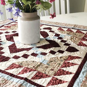 May include: A set of three ceramic mugs with a speckled, matte finish. The mugs are in shades of cream, light gray, and dark gray. Each mug has a simple, minimalist design, perfect for coffee or tea.