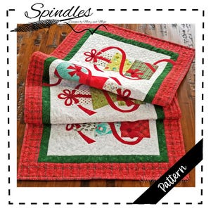 May include: A folded Christmas-themed quilt featuring gift box designs with red ribbons on a white background. The quilt has a red and green border and the word "Pattern" on a black diagonal banner.