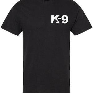 May include: Black t-shirt with a white "K-9" logo on the upper left chest. The logo features the text "K-9" with a silhouette of a dog. The shirt has short sleeves and a crew neck.