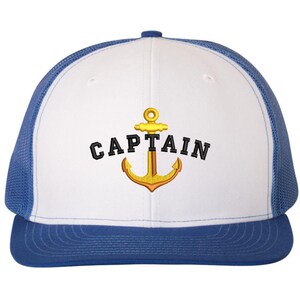 May include: White and blue trucker hat with a gold anchor and the word "CAPTAIN" embroidered on the front.