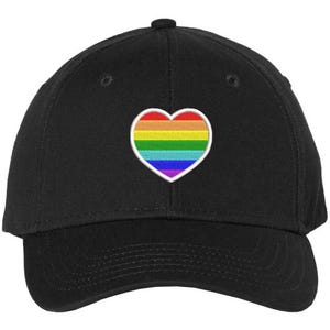 May include: A black baseball cap with a rainbow heart embroidered on the front.