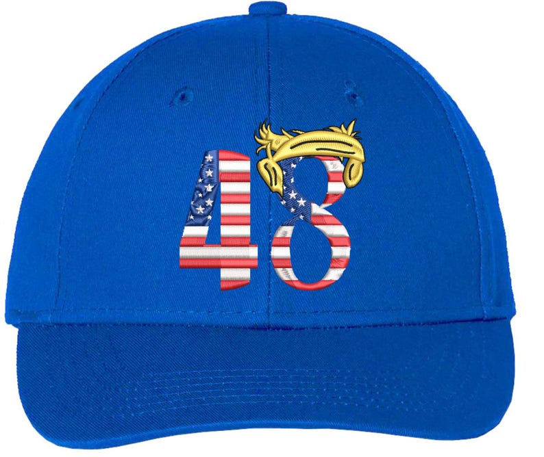 May include: Royal blue baseball cap with the number "48" embroidered on the front. The "4" is designed with the American flag, and the "8" features a gold-coloured hair design.