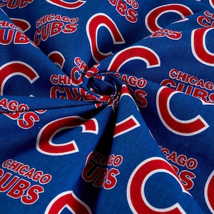 May include: Blue fabric with a repeating pattern of the Chicago Cubs logo in red and white. The logo features the letter "C" with a white outline and the words "Chicago Cubs" in white.