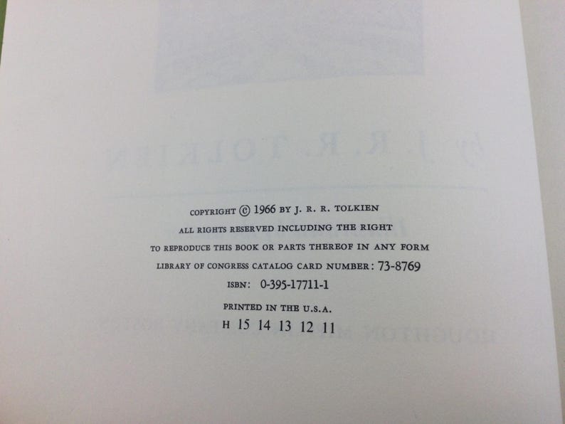 May include: A close-up of a book page with text. The text includes copyright information from 1966 by J.R.R. Tolkien, ISBN, and Library of Congress catalog card number. The book was printed in the U.S.A.