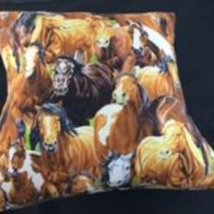 May include: A square throw pillow featuring a detailed, multi-colored print of a herd of horses. The design includes various horse breeds in shades of brown, chestnut, black, and white, depicted in a crowded, overlapping composition.