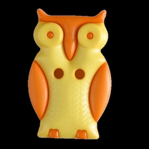 May include: A yellow and orange plastic owl button with two holes. The owl has a textured surface and large, round eyes.