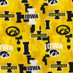 May include: Yellow fabric with a repeating pattern of black and white "IOWA" and "HAWKEYES" text, and a black and white stylized hawk logo.