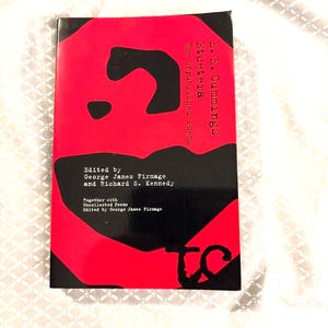 May include: A book titled "Etcetera The Unpublished Poems" by E.E. Cummings. The cover is red with a black abstract design and white text. The book is edited by George James Firmage and Richard S. Kennedy.