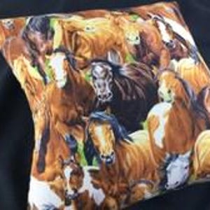 May include: A square throw pillow featuring a vibrant, repeating pattern of multiple horses in various shades of brown, chestnut, and white. The horses are depicted in close proximity, showcasing detailed manes, facial markings, and expressive eyes.