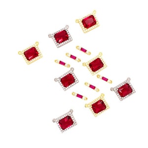 May include: An assortment of rectangular red gemstone charms with gold and silver settings. Some charms are surrounded by small clear stones. Also included are small, rectangular red gemstone charms with gold settings.