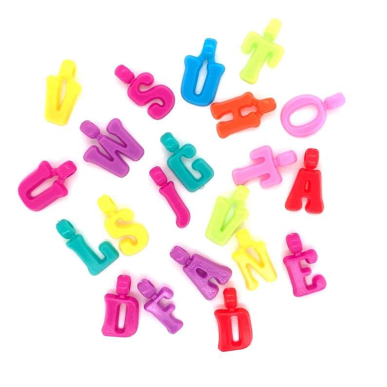 May include: A collection of colorful plastic letter beads in various colors, including red, orange, yellow, green, blue, purple, and pink. The beads are shaped like uppercase letters of the alphabet.
