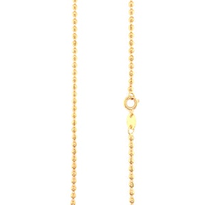 May include: A gold chain necklace with a bead design. The chain is approximately 18 inches long and features a lobster clasp.