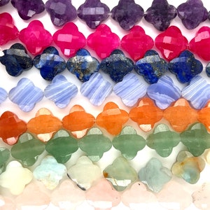 May include: A strand of colourful gemstone beads in a clover shape. The beads are made of amethyst, pink, blue, orange, green, and pink.