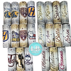 May include: A collection of glitter-covered tumblers with various designs. Some tumblers feature college logos and mascots, while others display names in elegant script. The tumblers have a silver, gold, and glittery finish.