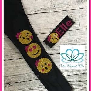 May include: Black leggings with three gold glitter smiley faces on the left leg. A pink glitter headband with the name "Elle" is included.