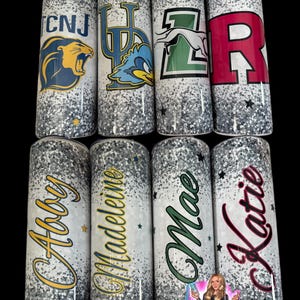 May include: Eight glitter-covered tumblers with various designs. Four tumblers feature college logos and initials, while the other four display names in cursive script. The tumblers have a silver glitter base with black accents and star details.