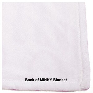 May include: Close-up of the back side of a white minky blanket. The fabric is soft and plush, with a subtle texture. The text "Back of MINKY Blanket" is printed on the bottom edge.